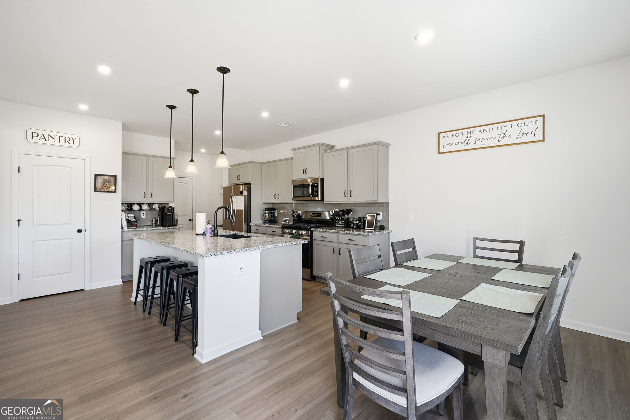 199 Graham Circle Adairsville, GA 30103 - Photo 13 of 49 a kitchen with a table chairs refrigerator and cabinets