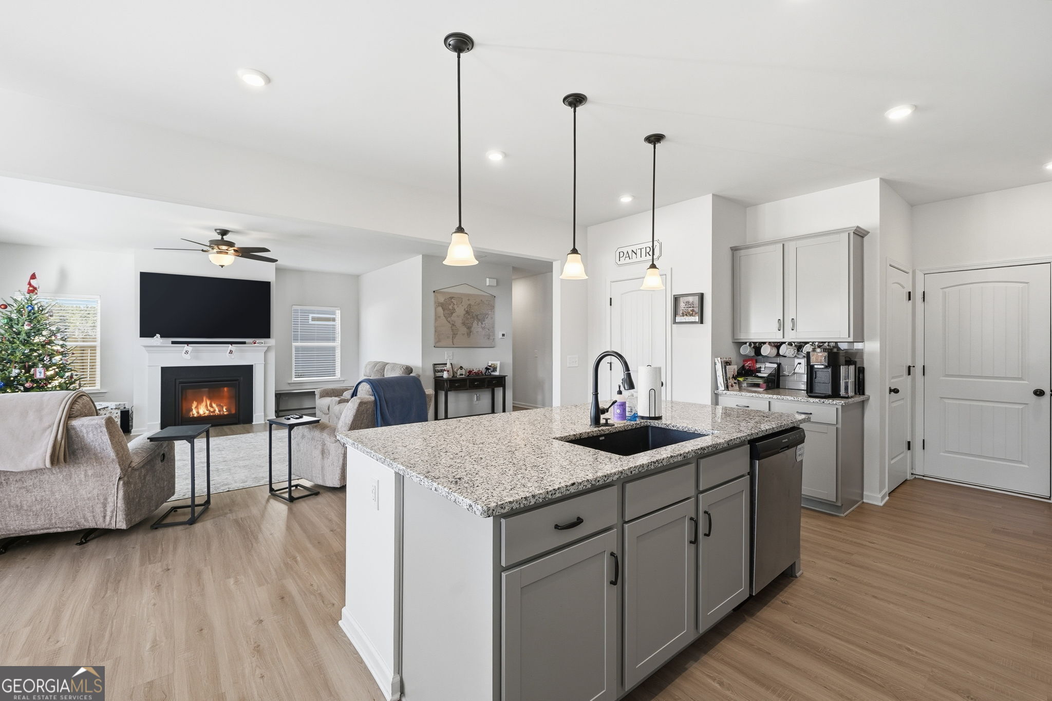 199 Graham Circle Adairsville, GA 30103 - Photo 14 of 49 a kitchen with stainless steel appliances granite countertop a sink a stove and a wooden floor