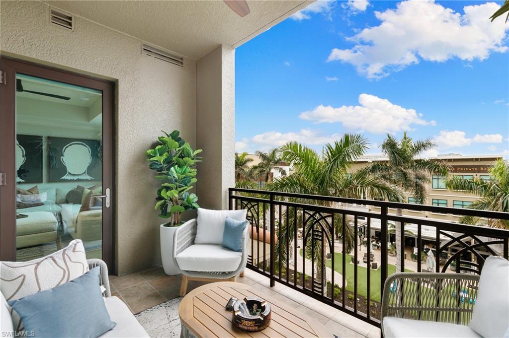 9115 Strada Place, Unit 5406 Naples, FL 34108 - Photo 2 of 50 a balcony with furniture and a potted plant