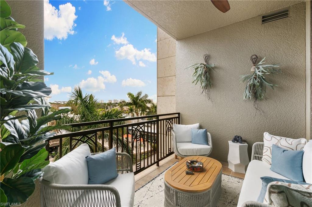 9115 Strada Place, Unit 5406 Naples, FL 34108 - Photo 30 of 50 a balcony with furniture and a potted plant