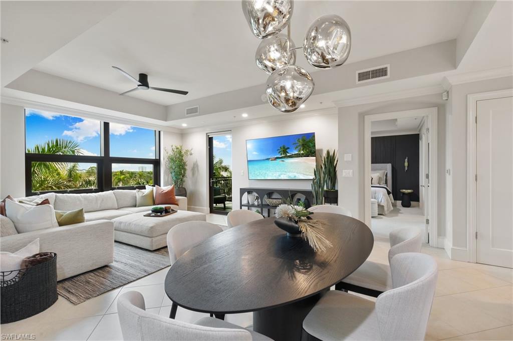 9115 Strada Place, Unit 5406 Naples, FL 34108 - Photo 3 of 50 a living room with furniture chandelier and a large window