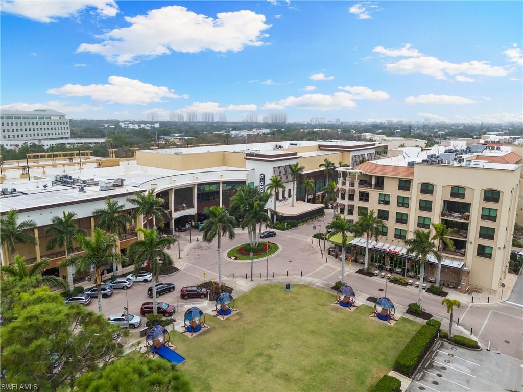 9115 Strada Place, Unit 5406 Naples, FL 34108 - Photo 39 of 50 a view of a lake with lawn chairs