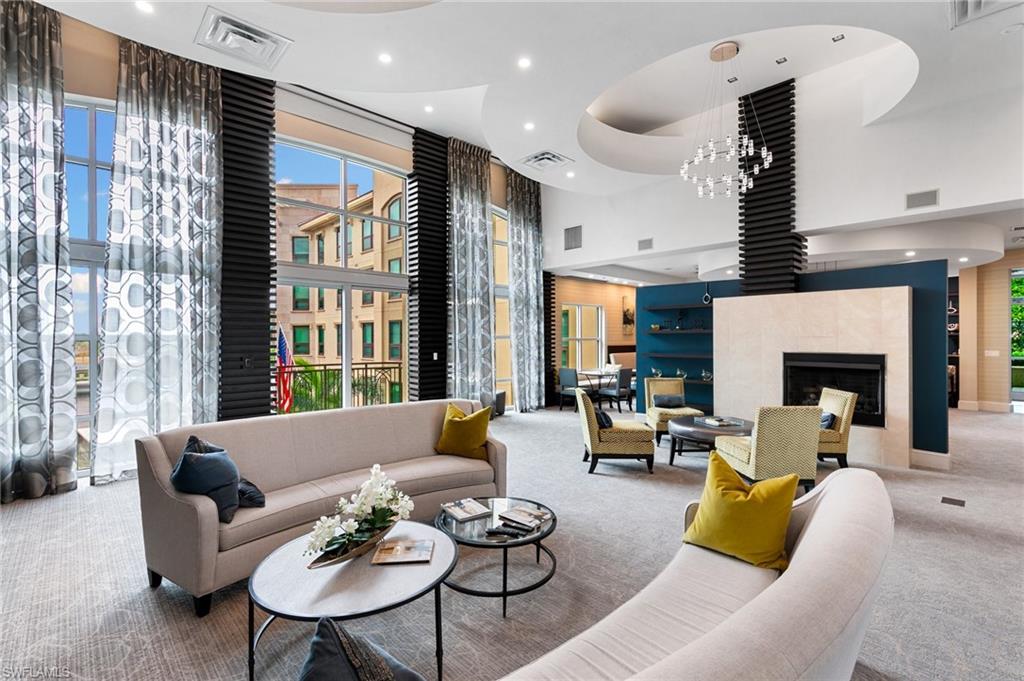 9115 Strada Place, Unit 5406 Naples, FL 34108 - Photo 43 of 50 a living room with furniture and a fireplace