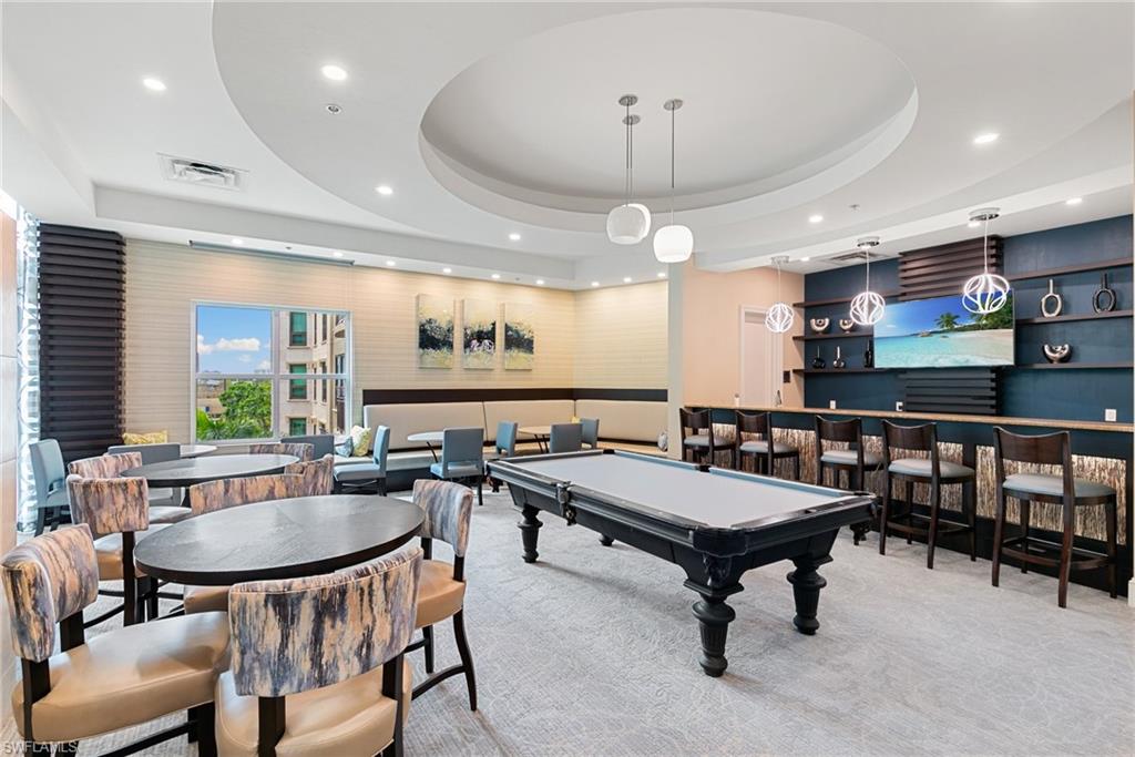 9115 Strada Place, Unit 5406 Naples, FL 34108 - Photo 44 of 50 a room with lots of furniture and a wooden floor