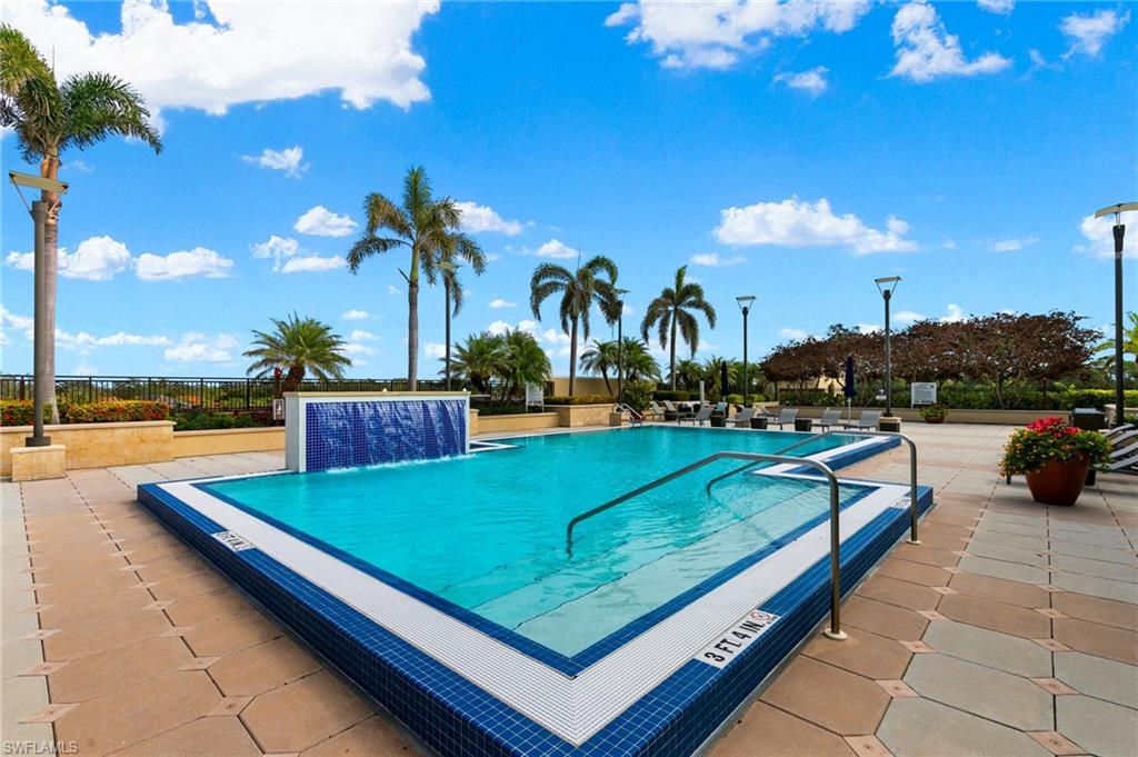 9115 Strada Place, Unit 5406 Naples, FL 34108 - Photo 47 of 50 a view of a swimming pool with lounge chairs