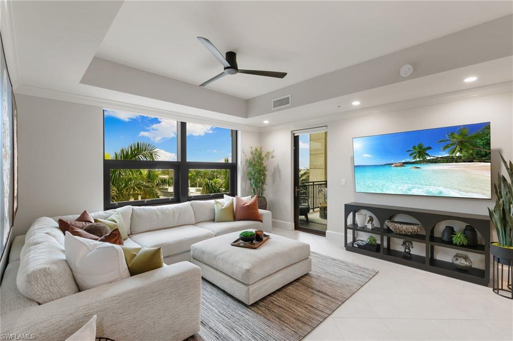 9115 Strada Place, Unit 5406 Naples, FL 34108 - Photo 6 of 50 a living room with furniture and a flat screen tv