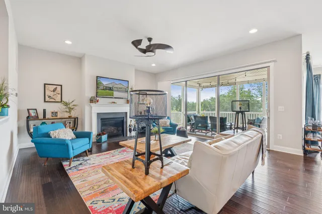 a kitchen with stainless steel appliances granite countertop a stove top oven a sink and white cabinets with wooden floor