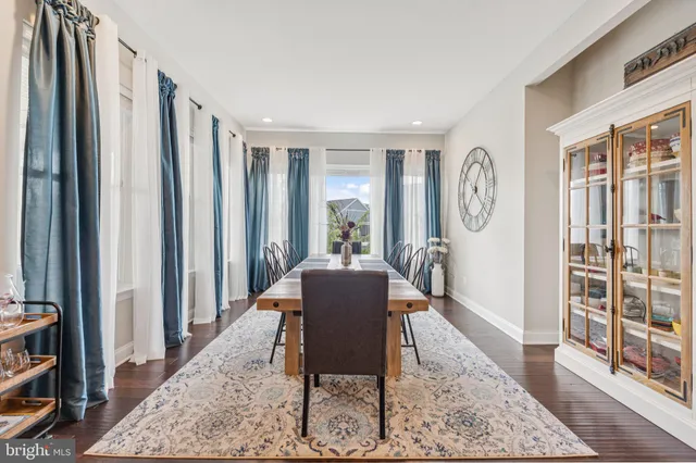 a bedroom with a bed lamp and a large mirror with wooden floor