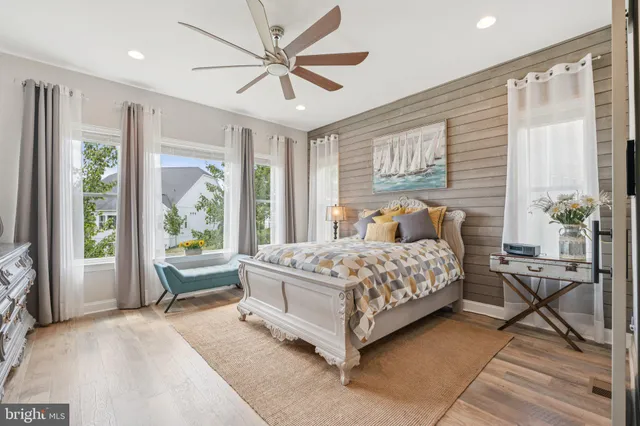 a bathroom with a tub a mirror and shower