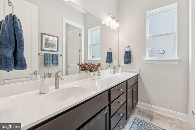 a bathroom with a sink toilet and a mirror