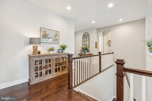 a bedroom with a bed a couch and a chandelier