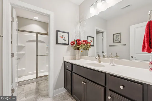 an aerial view of ocean and residential houses with outdoor space