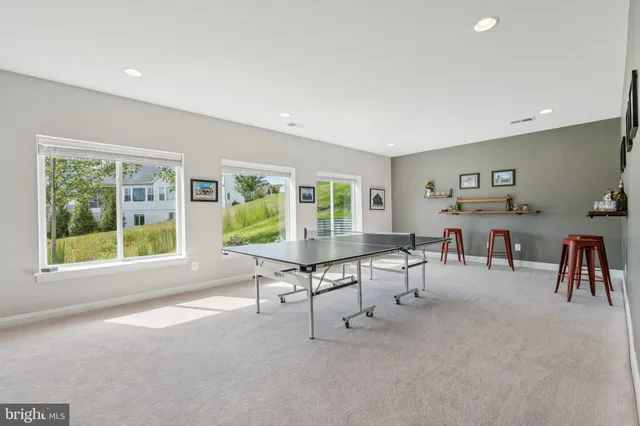 an aerial view of a residential houses with yard