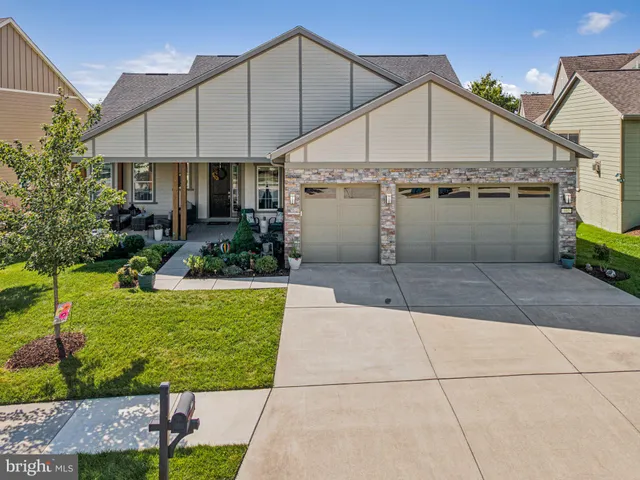a view of tennis court with houses in the background