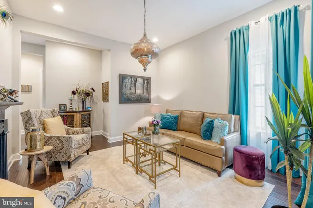a living room with furniture a chandelier and a window