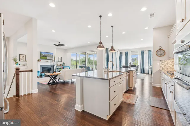 a living room with fireplace furniture and a large window