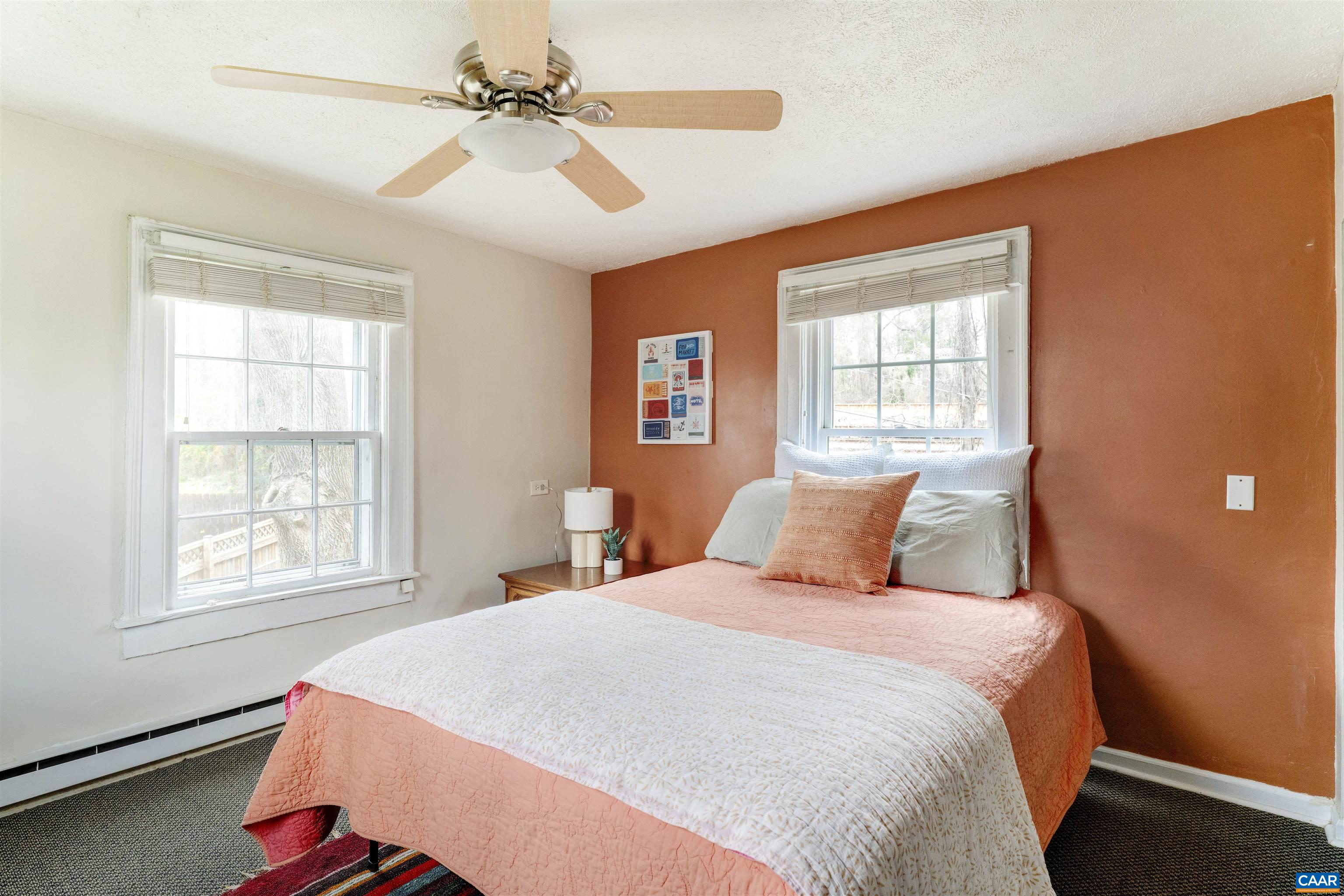 1625 Grove St Extension Charlottesville, VA 22903 - Photo 12 of 24 a bedroom with a large bed and a chandelier