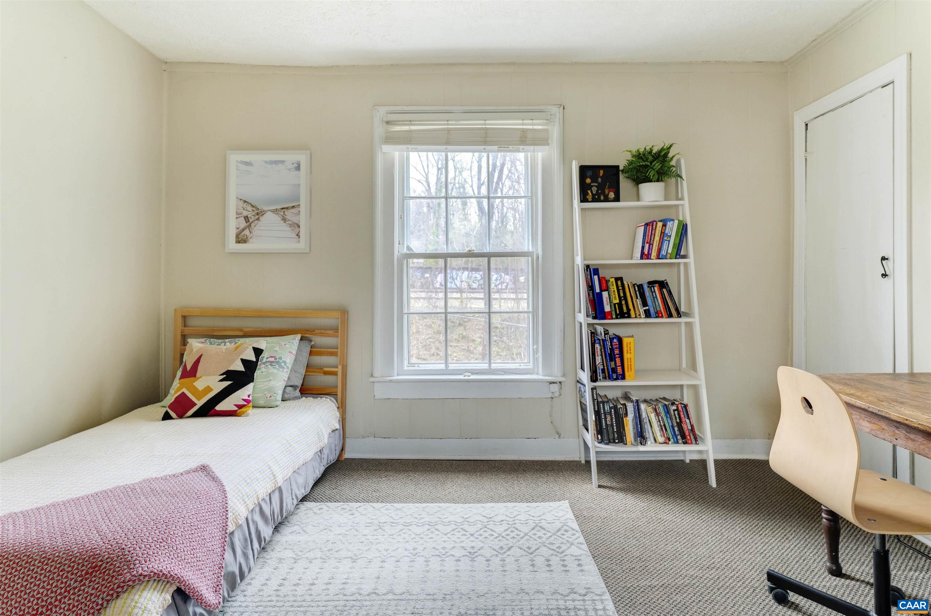 1625 Grove St Extension Charlottesville, VA 22903 - Photo 14 of 24 a bedroom with a bed and a book shelf