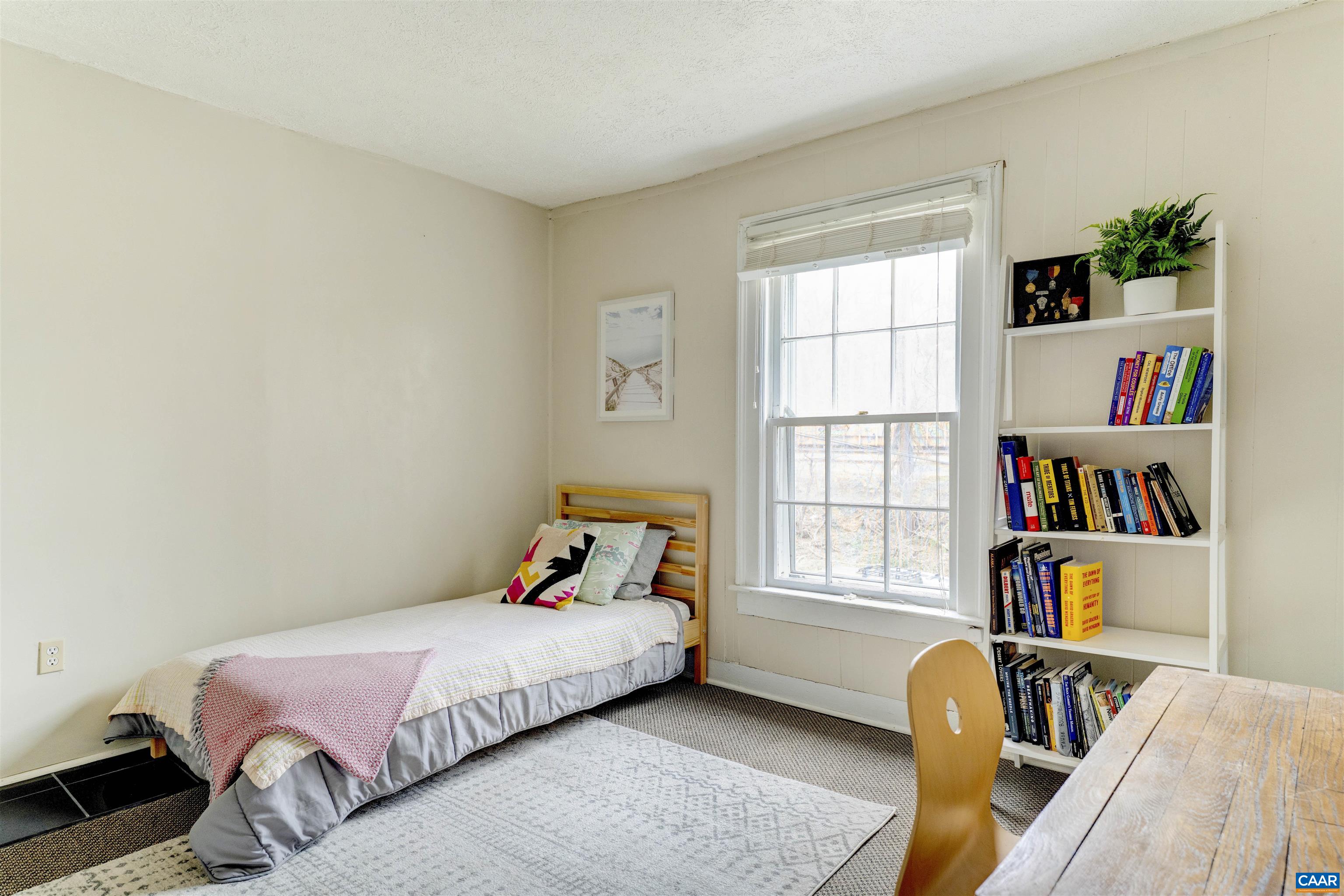 1625 Grove St Extension Charlottesville, VA 22903 - Photo 15 of 24 a bedroom with a bed a dresser and a book shelf