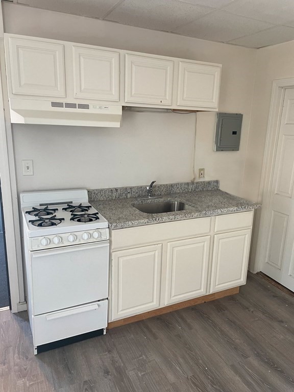 159 Nashua Street Fall River, MA 02721 - Photo 8 of 15 a kitchen with granite countertop white cabinets and white appliances