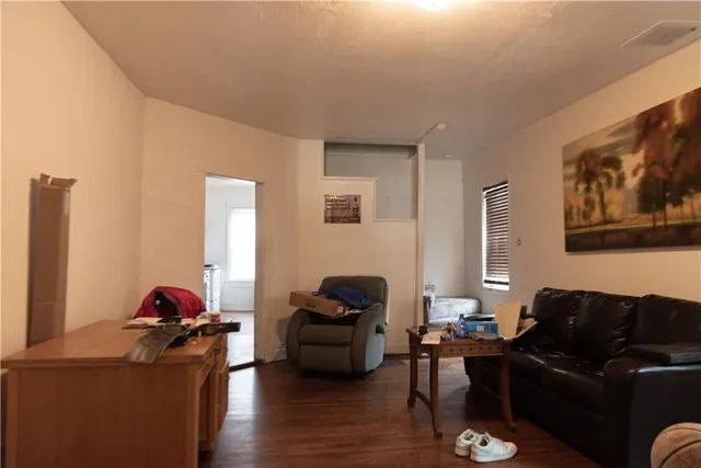 a living room with furniture and a lamp
