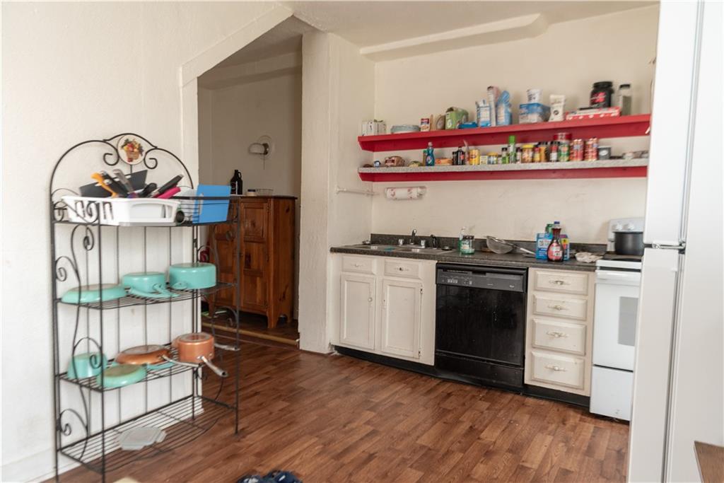 47-49 South S 5th Street Indiana, PA 15701 - Photo 12 of 14 a kitchen with stainless steel appliances a stove a chimney a refrigerator and cabinets