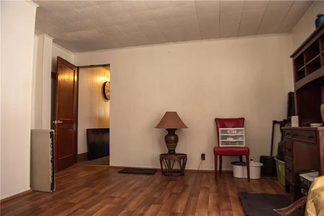 a view of a workspace with furniture and wooden floor