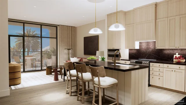 a kitchen with a dining table chairs sink and white cabinets