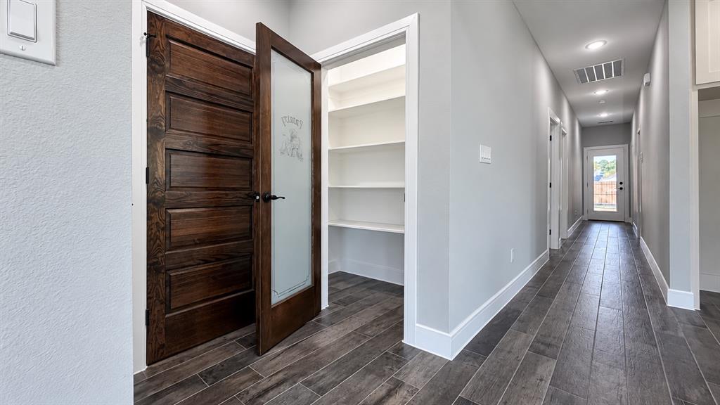 302-304 West Pine Street Whitewright, TX 75491 - Photo 21 of 38 Wood-look plank flooring extending through the hallway