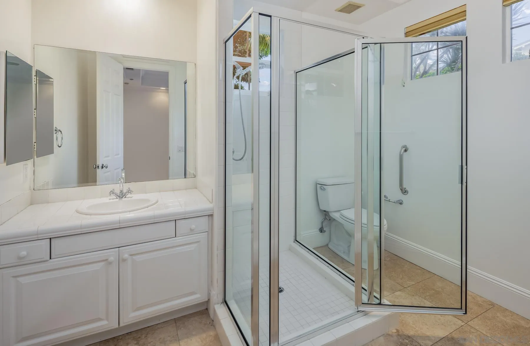 1650 Bella Laguna Court Encinitas, CA 92024 - Photo 23 of 41 a bathroom with a shower sink and mirror
