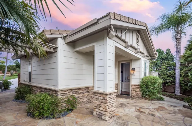 a front view of a house with a garden