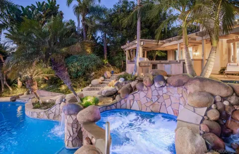 a view of a patio with table and chairs potted plants and large tree