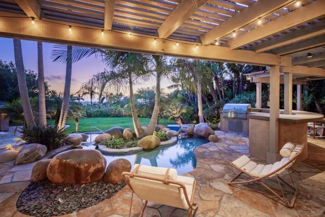 a living room with patio furniture and a floor to ceiling window