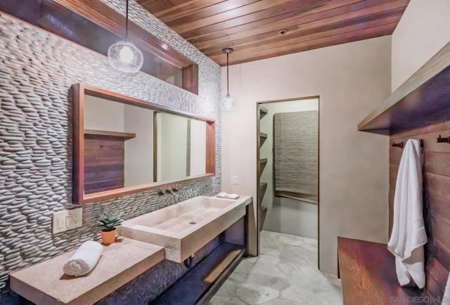 a bathroom with a sink a vanity and a mirror