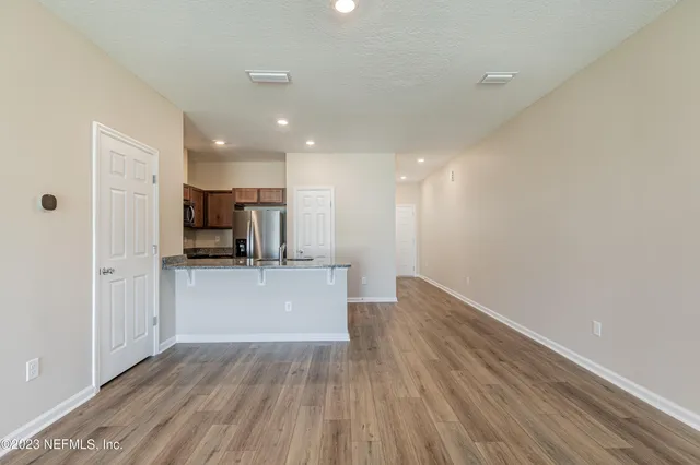 a view of kitchen with stainless steel appliances refrigerator and microwave