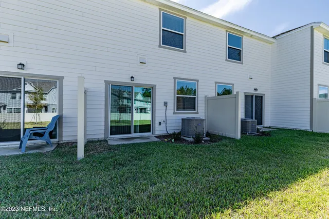 a view of an house with backyard space and balcony