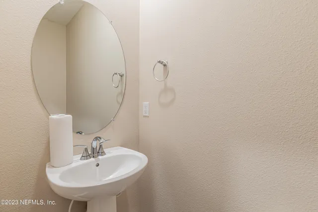 a bathroom with a sink and mirror