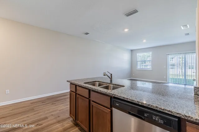 a kitchen with granite countertop a sink and a window