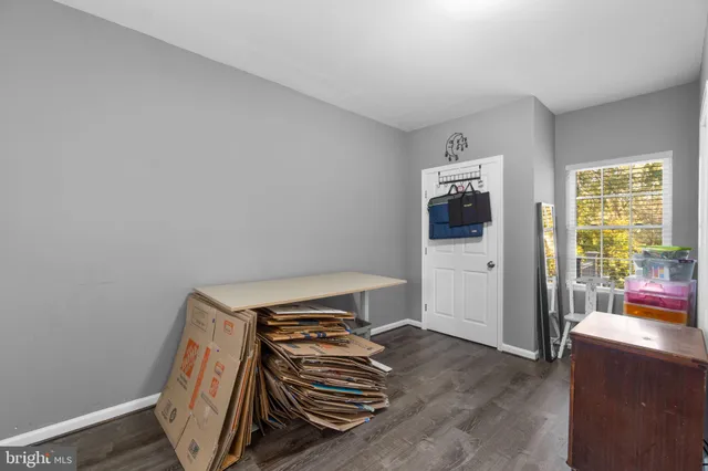 a view of a livingroom with wooden floor and furniture