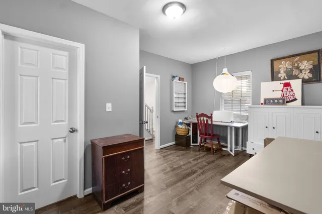 a living room with furniture and a dining table