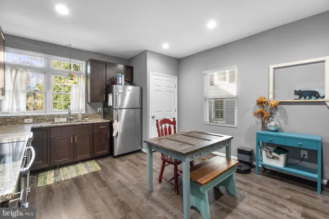 a kitchen with refrigerator cabinets and wooden floor