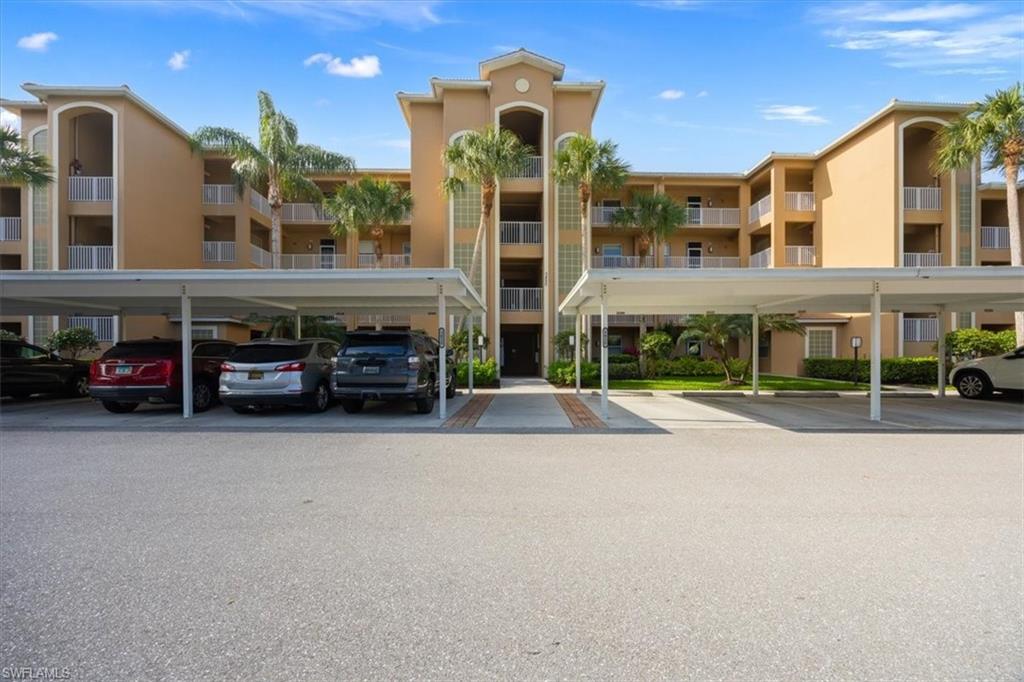 3820 Sawgrass Way, Unit 3013 Naples, FL 34112 - Photo 1 of 28 a couple of cars parked in front of a building