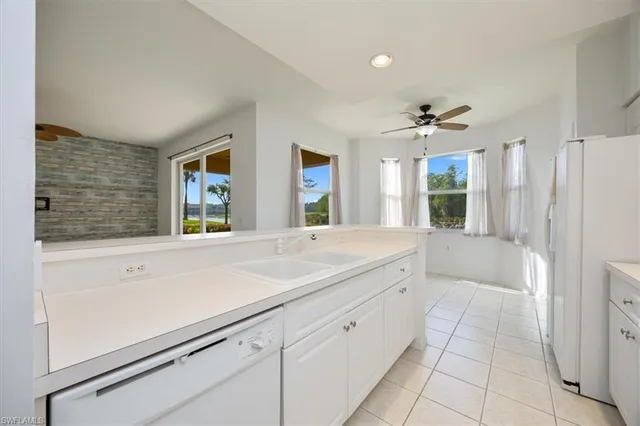 a spacious bathroom with a shower sink and mirror