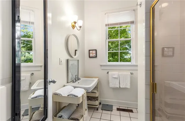 a bathroom with a sink a mirror and a window