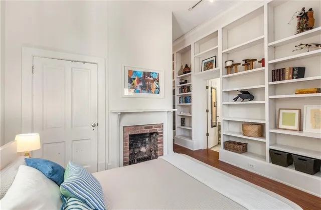 a bedroom with a bed and a fireplace