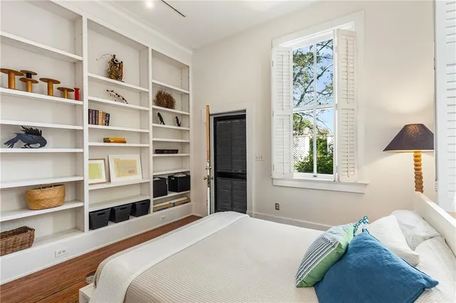 a bedroom with a bed and a window