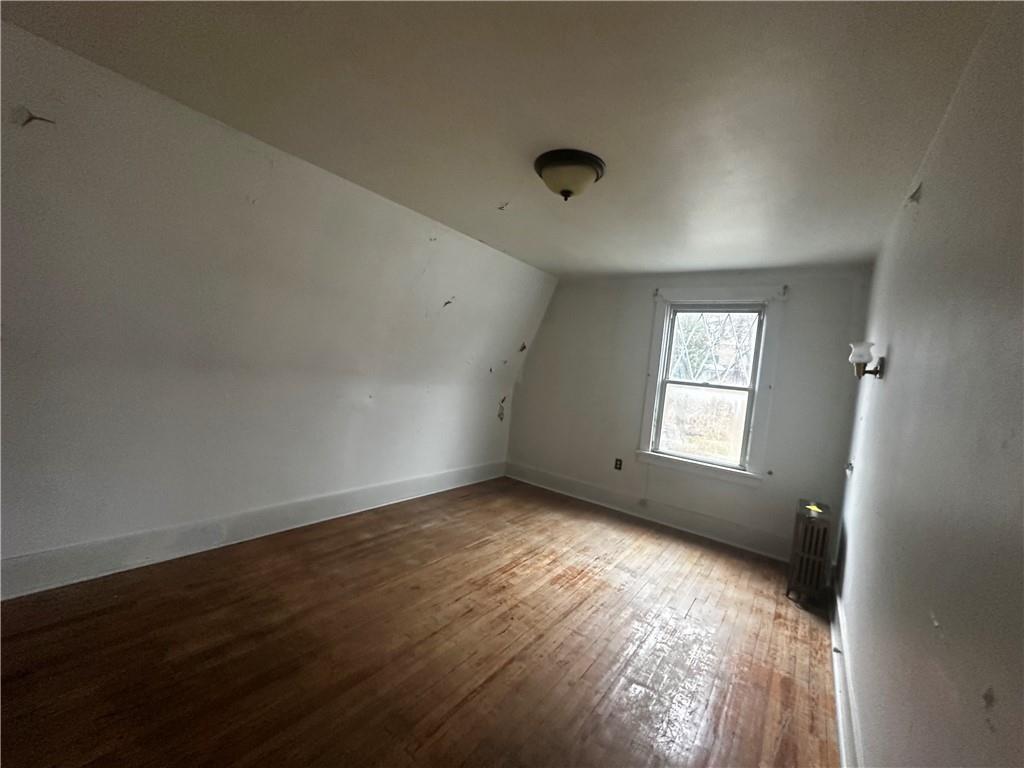 325 Elm Road Ambridge, PA 15003 - Photo 9 of 13 an empty room with wooden floor and windows