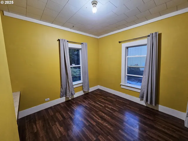 a view of room with wooden floor