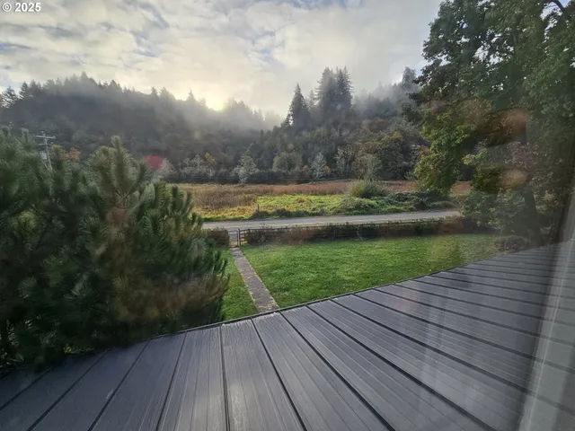 a view of a wooden deck and a yard