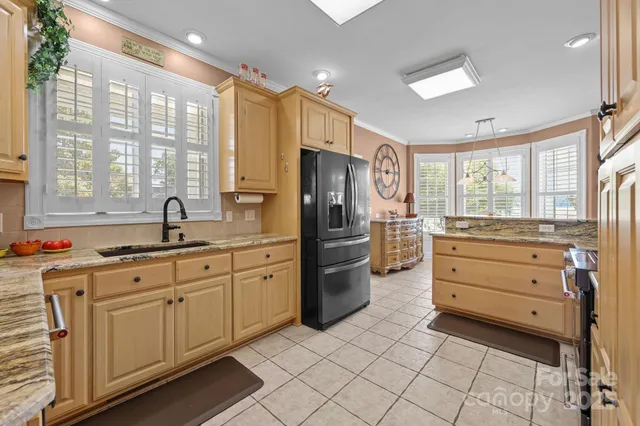 a dining room with furniture and large windows